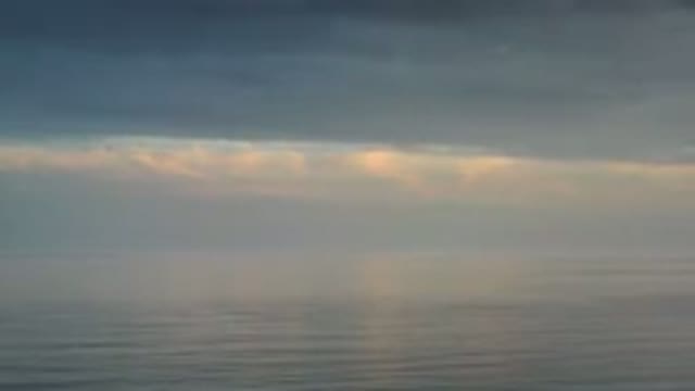 LOS CABOS MEXICO-2020: Sliver Of Sunlight And Blue Sky Peaks Through Clouds Over Ocean