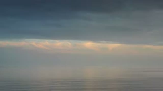 LOS CABOS MEXICO-2020: An Aerial View Of Ocean Waves Rolling Through Light Fog