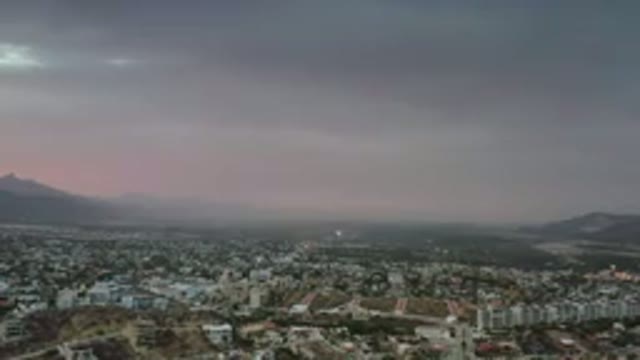 LOS CABOS MEXICO-2020: Camera Zooming Into A City In The Night Sky With A