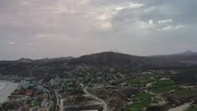LOS CABOS MEXICO-2020: Cloudy Sky Above City With Roads And Mountainous Views In
