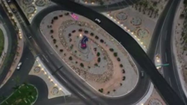 LOS CABOS MEXICO-2020: Aerial View Of Cars Driving Around A Loop And Highway At Dusk