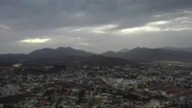 LOS CABOS MEXICO-2020: Dark Cloudy Sky Mountain Backdrop Suburban Town Valley