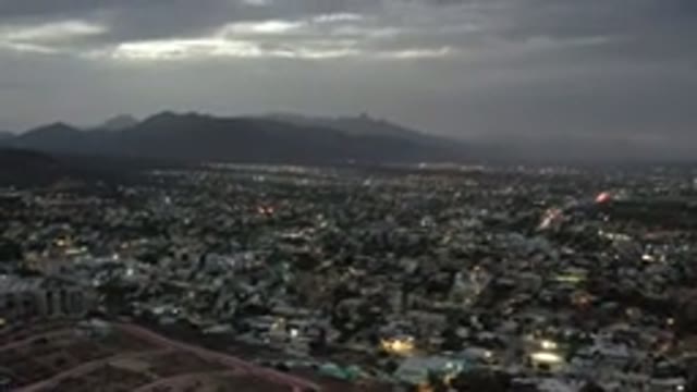 LOS CABOS MEXICO-2020: Lights Coming On In A City At Sunset With Mountains In