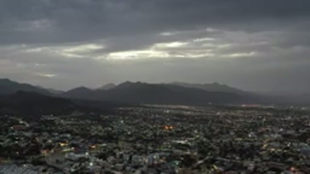 LOS CABOS MEXICO-2020: Sunlight Peeks Through Dark Clouds Casting Shadow Over