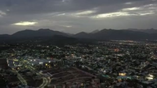 LOS CABOS MEXICO-2020: Cloudy Skies With Dark Mountains Over A City During The Evening