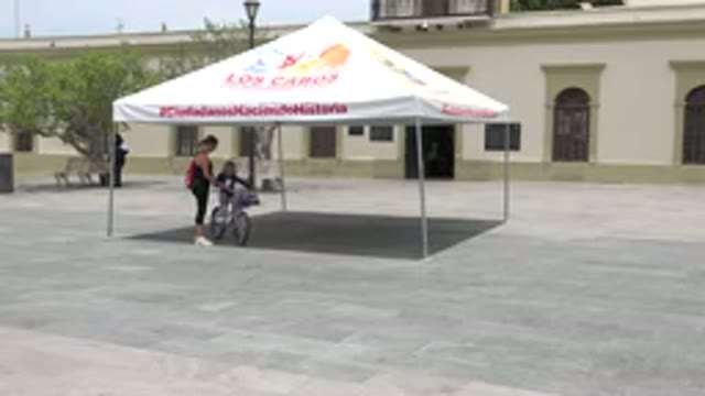 LOS CABOS MEXICO-2020: A Woman Moving From Shed And Teaching Her Daughter To Ride A Bicycle
