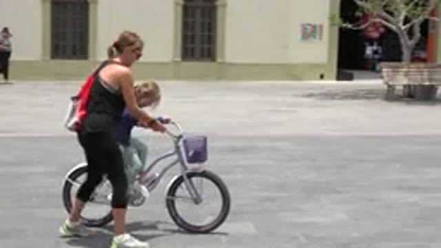 LOS CABOS MEXICO-2020: Girl Being Taught By Woman How To Ride Bicycle Without