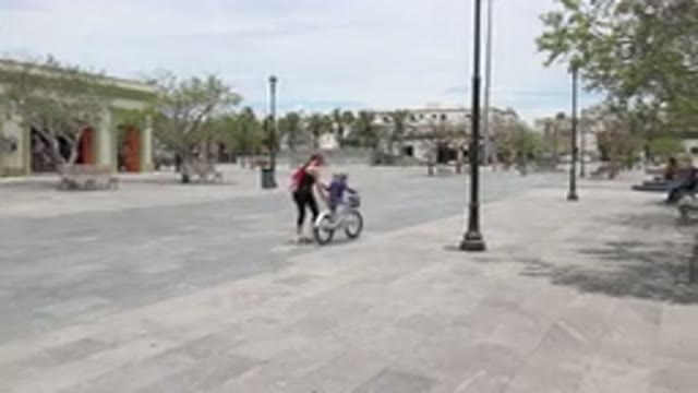 LOS CABOS MEXICO-2020: Mom Is Teaching Her Child How To Ride A Bike Without
