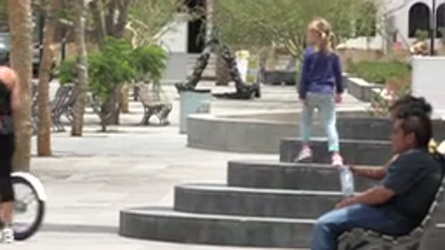 LOS CABOS MEXICO-2020: Woman Walking Beside A Bike As A Little Girl Walks