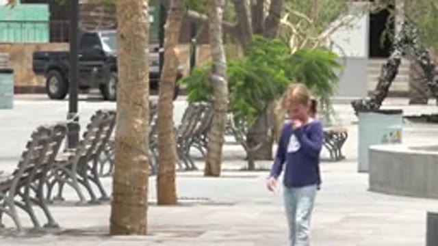 LOS CABOS MEXICO-2020: A Blonde Girl With A Ponytail Walks Toward Her Mother