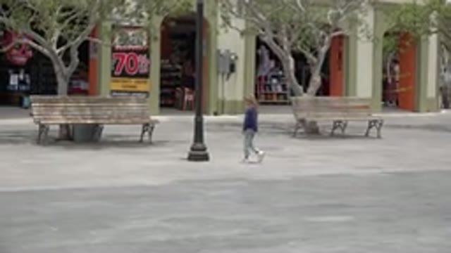 LOS CABOS MEXICO-2020: Little Girl Walking Up To A Bench In The Middle Of A City