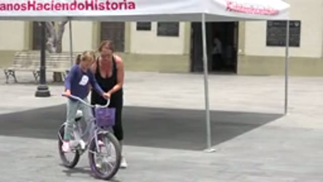 LOS CABOS MEXICO-2020: A Mother Helping Her Daughter Ride A Bicycle
