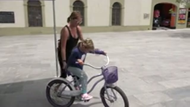 LOS CABOS MEXICO-2020: Mum Helping Her Daughter Learn To Ride A Bicycle In An