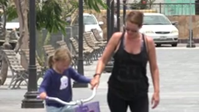 LOS CABOS MEXICO-2020: Mother Helping Her Daughter Learn to Ride a Bike