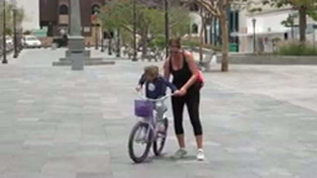 LOS CABOS MEXICO-2020: Mother Holds the Bike While Daughter Tries to Learn