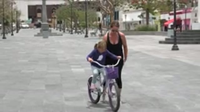 LOS CABOS MEXICO-2020: Mother Teaching Young Daughter How To Safely Ride A