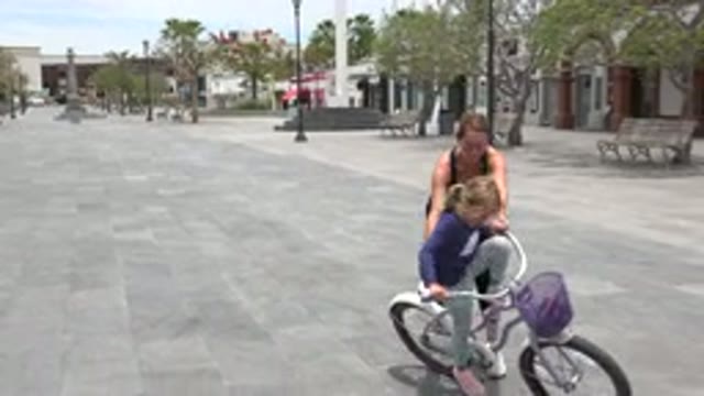 LOS CABOS MEXICO-2020: Mother Teaches Her Daughter to Ride a Bike