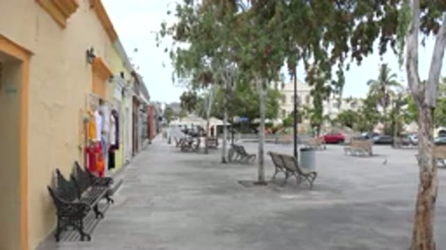 LOS CABOS MEXICO-2020: Empty Park Benches In A City Square Surrounded By