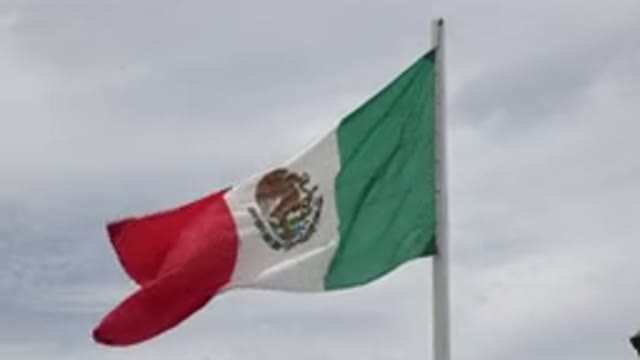 LOS CABOS MEXICO-2020: Mexican Flag Blowing in the Breeze on a Cloudy Day