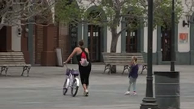 LOS CABOS MEXICO-2020: An Adult On A Bicycle And A Child In The Park