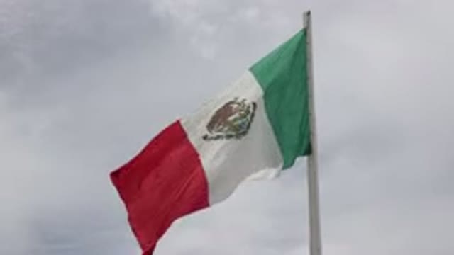 LOS CABOS MEXICO-2020: Flag Blowing In The Wind As A Dark Sky Covers It