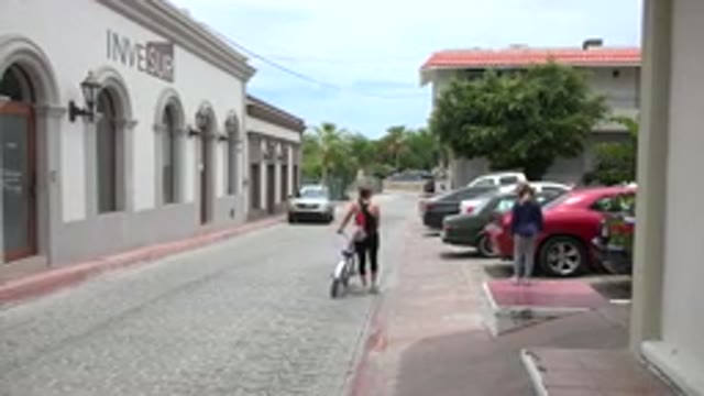 LOS CABOS MEXICO-2020: A Woman Teaching Cycling To Her Daughter In An Outdoor Setting