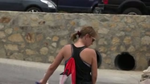 LOS CABOS MEXICO-2020: Sporty Mother Pushing Little Girl on Purple Bike