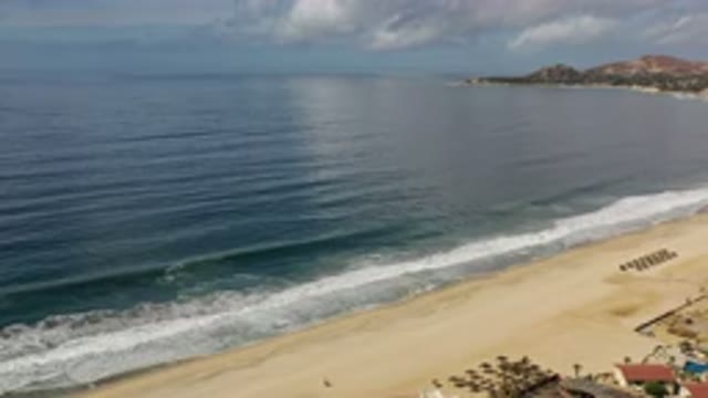 LOS CABOS MEXICO-2020: An Empty Beach With Small Houses and Calm Ocean Waves