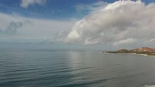 LOS CABOS MEXICO-2020: Sunny Day Clouds Over Blue Water On Beach Midday Shot Of
