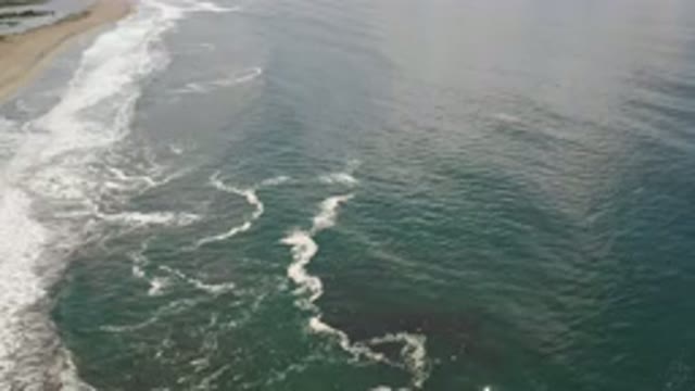 LOS CABOS MEXICO-2020: Crashing Blue Ocean Waves Ebbing And Flowing Onto A Sandy Beach