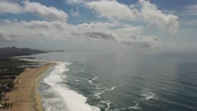 LOS CABOS MEXICO-2020: Waves Crashing On An Empty Beach With A Clear Sky