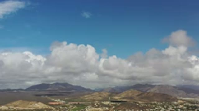 LOS CABOS MEXICO-2020: Blue Sky With Mountains And Some Buildings