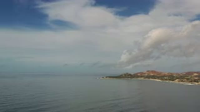 LOS CABOS MEXICO-2020: A View Of Land With Sea Around It With Sky Far Behind The
