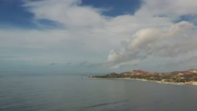 LOS CABOS MEXICO-2020: Aerial View Of A Sea, Blue Sky With Clouds And A Piece Of Land