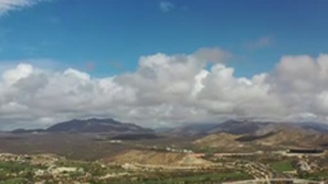 LOS CABOS MEXICO-2020: White Cumulus Clouds Sprinkled Across Blue Sky Above