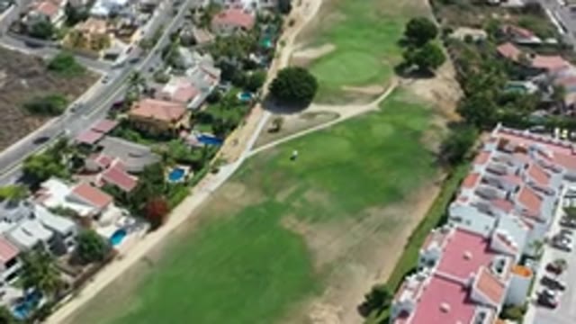 LOS CABOS MEXICO-2020: Green Field With Trees Dividing Houses In A Beautiful