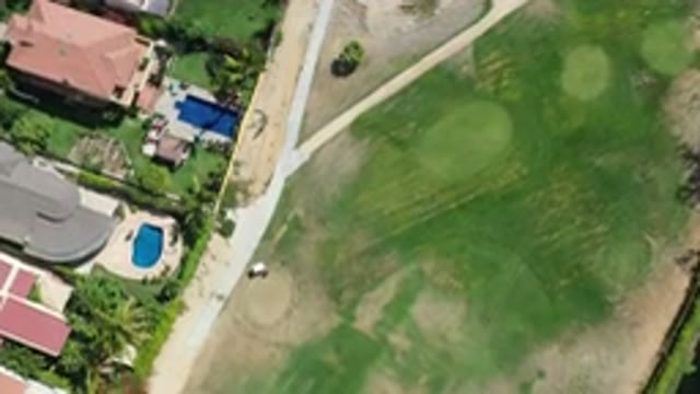 LOS CABOS MEXICO-2020: Drone Flying Over Golf Course Next To Large Houses With