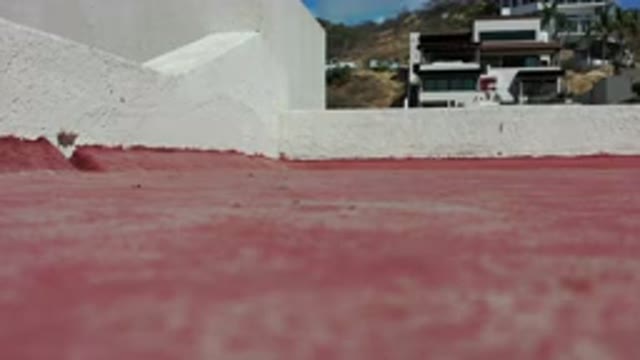 LOS CABOS MEXICO-2020: Red Floor With Short White Walls Next To A Building