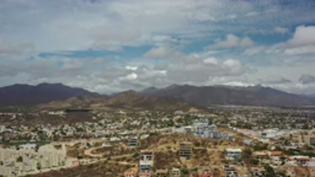 LOS CABOS MEXICO-2020: Moving Towards The Mountain Over A Suburban Town Nestled