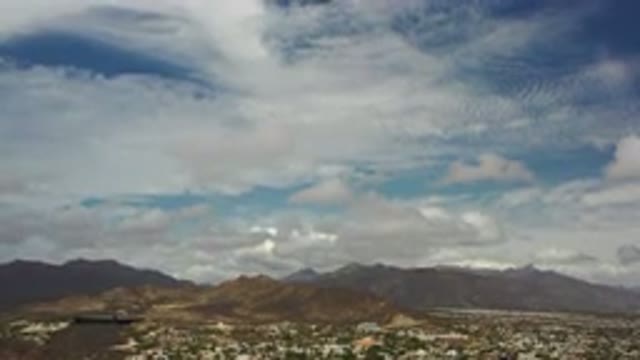 LOS CABOS MEXICO-2020: The Blue Sky Between Clouds Over The City At The Foot Of A Hill
