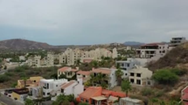 LOS CABOS MEXICO-2020: Buildings And Rooftop Of City With Mountains In The Background