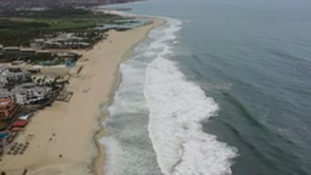 LOS CABOS MEXICO-2020: Shot Of Waves Lapping Against A Beach Near A Seaside
