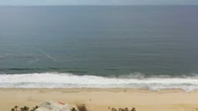 LOS CABOS MEXICO-2020: Aerial View Of Waves Crashing Onto Sandy Beach On A