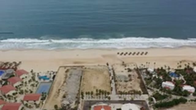 LOS CABOS MEXICO-2020: Aerial Footage of Ocean Crashing Against Sandy Beach Near