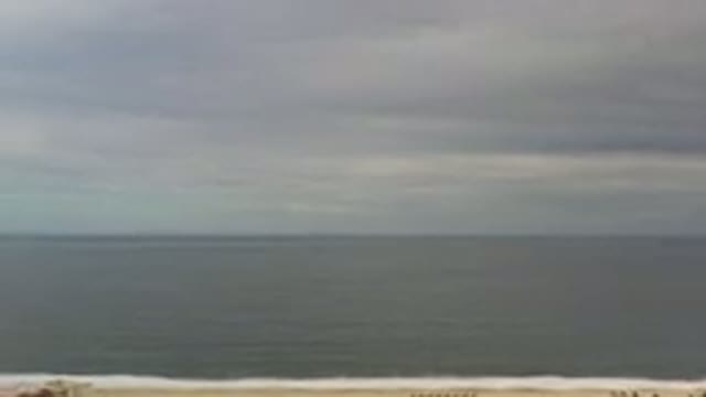 LOS CABOS MEXICO-2020: Calm Beach On A Cloudy Day With Grayish Waters And Some People