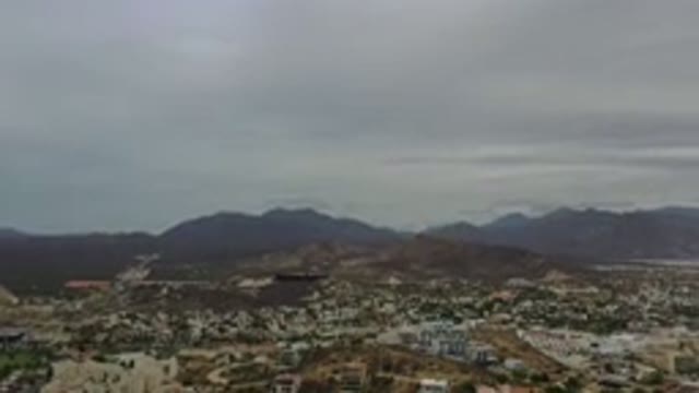 LOS CABOS MEXICO-2020: Gray Clouds Cast Shadows On Tall Mountains Overlooking