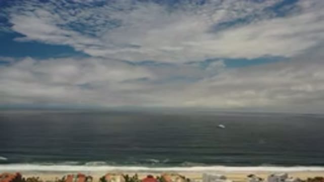 LOS CABOS MEXICO-2020: White Clouds Spread Throughout A Blue Sky Over Beach And Ocean