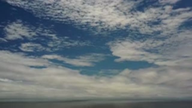 LOS CABOS MEXICO-2020: Panning Downward On A Cloudy Sky Above The Ocean On A