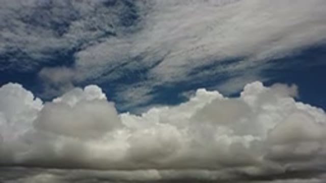 LOS CABOS MEXICO-2020: White Puffy Cumulus Clouds Below Light Stratus Clouds In