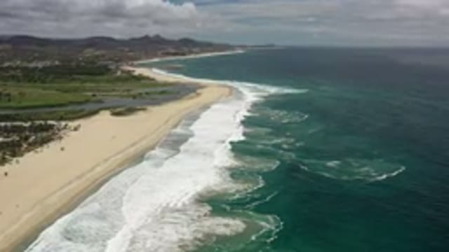 LOS CABOS MEXICO-2020: Shoreline With White Crashing Waves Dark Blue Ocean And